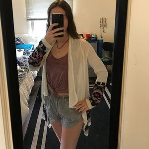 White cardigan with tribal print accents.